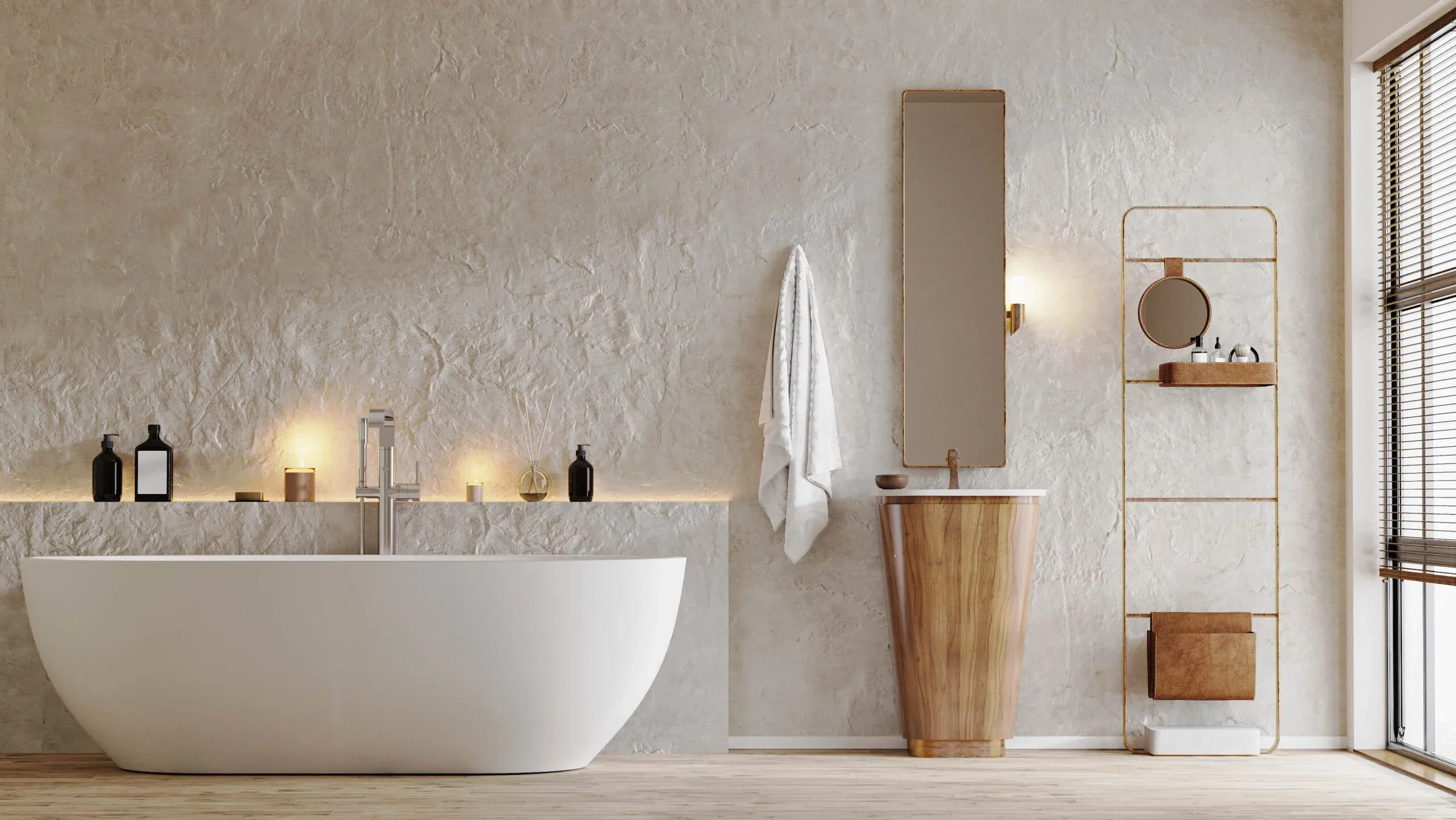 A minimalist bathroom featuring a white freestanding bathtub against a textured plaster wall, a tapered wooden pedestal sink, and warm ambient lighting.
